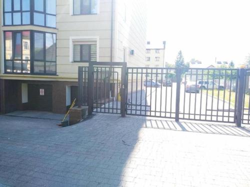 a metal gate in front of a building at Lux na Druhetiv in Uzhhorod