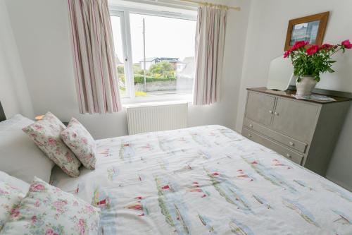 a bed in a bedroom with a window and a bed sidx sidx sidx at Mornant in Trearddur