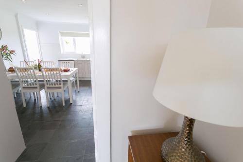 a kitchen and dining room with a table and chairs at Mornant in Trearddur