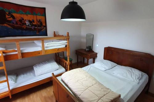 a bedroom with two bunk beds and a lamp at Belle maison spacieuse proximité mer in Le Crotoy