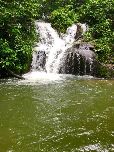 a waterfall in the middle of a body of water at Apt Flat 225 Condomínio Pedra do Rodeadouro in Bonito
