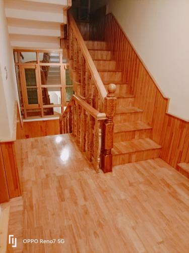 a staircase in a house with wooden floors at Moonshine Homestay Kashmir in Srinagar