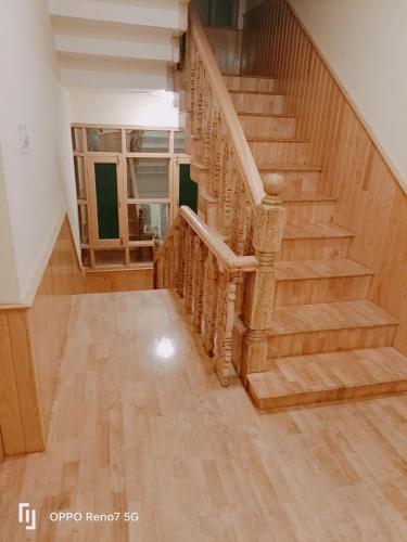 a staircase in a house with wooden floors at Moonshine Homestay Kashmir in Srinagar