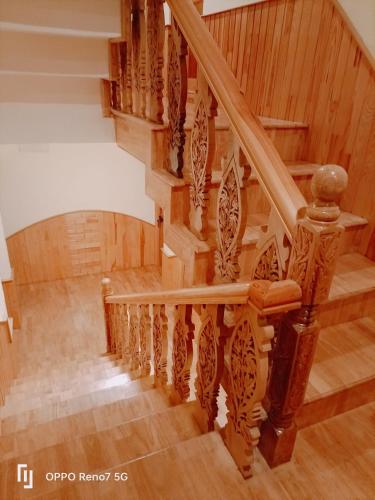 an image of a wooden spiral staircase in a house at Moonshine Homestay Kashmir in Srinagar