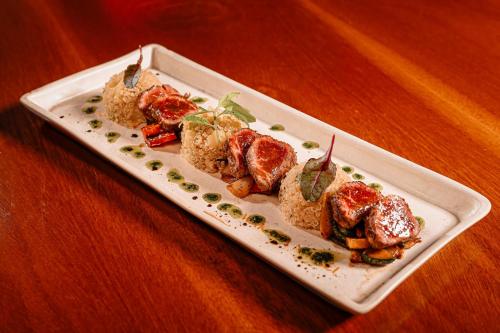a plate of food on a wooden table at Grand Victoria Boutique Hotel in Loja