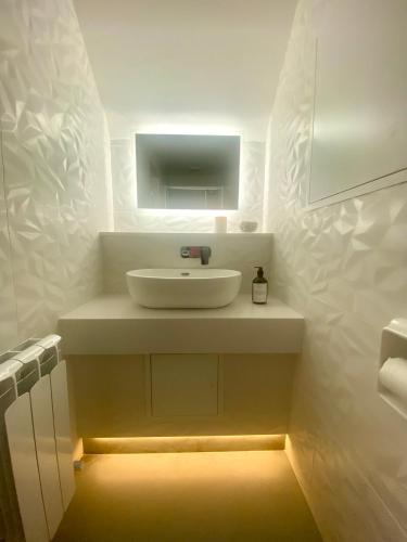 a bathroom with a sink with a light under it at Dillon School House - Luxury in the countryside in Roscommon