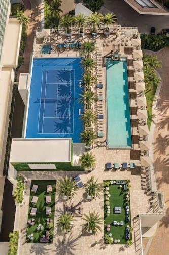an overhead view of a resort pool with palm trees at HYDE 2BR & 2BA Oceanview - No Hotel Fees thru Dec 31 in Hollywood