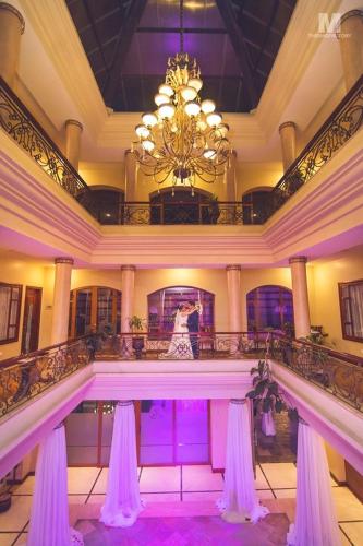a bride and groom standing in the middle of a pool in a building at Grand Victoria Boutique Hotel in Loja