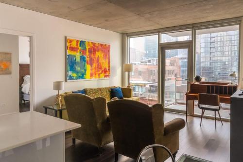 a living room with a couch and some chairs at 2BR Executive Suite With Fast Wi-Fi in Chicago