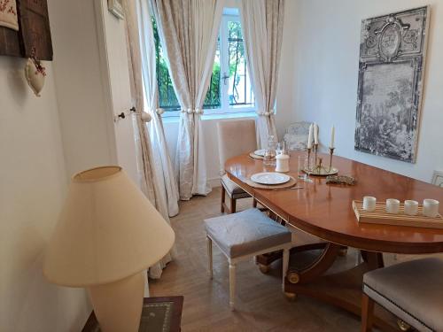 uma sala de jantar com uma mesa e um candeeiro em Le Cottage de Sainte Valière (Jacuzzi et terrasse ) em Sainte-Vallière