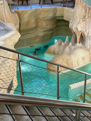 a person swimming in a pool in a water park at Arc 1950 Ap 171 Résidence les Sources de Marie in Bourg-Saint-Maurice