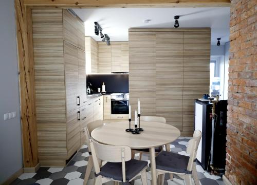 a kitchen with a table and chairs in a room at Kur palikt Salacgrīvā in Salacgrīva