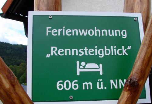 a green sign that reads ferwegianushima at Ferienwohnung Rennsteigblick in Suhl