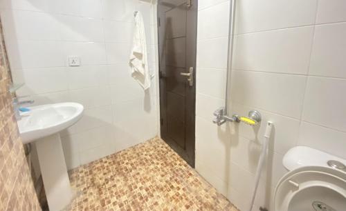 a bathroom with a shower and a sink and a toilet at Viceroy Luxury Hotel Apartments Islamabad in Islamabad