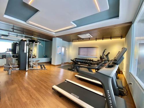 a fitness room with a treadmill and a gym at Elegant City Center Condo in Santo Domingo