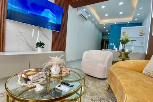 a living room with a glass table and a couch at Elegant City Center Condo in Santo Domingo