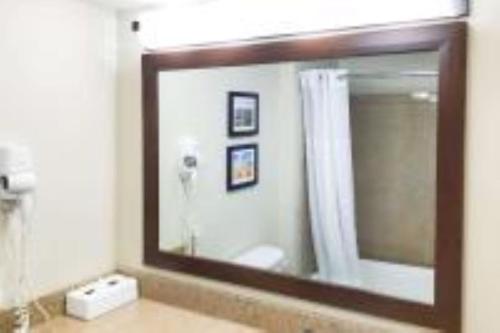 a bathroom with a large mirror and a sink at Quality Inn & Suites Yuma in Yuma