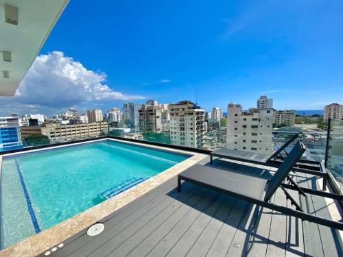 a swimming pool on the roof of a building at Great Centric Apt, Pool, in Santo Domingo