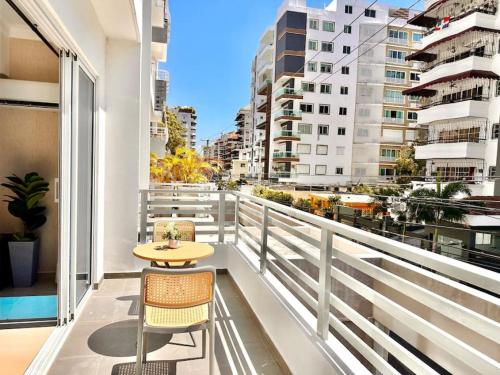 a balcony with a table and chairs and a view of a city at Beautiful Condo in Bella Vista in Los Prados
