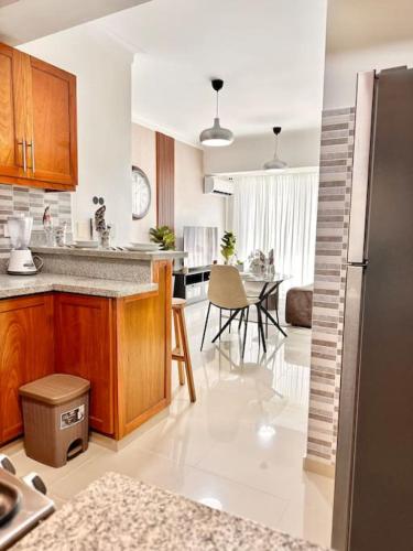 a kitchen with a counter and a dining room at Beautiful Condo in Bella Vista in Los Prados