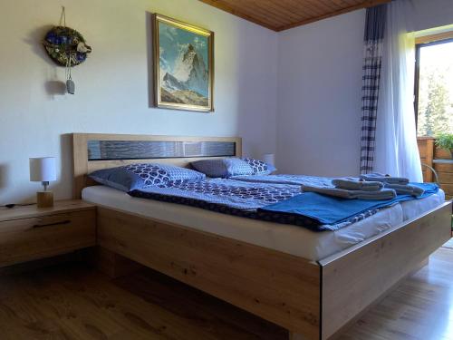 a bedroom with a large bed with blue sheets at Haus Sperleiten in Abtenau