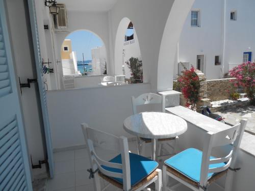 a table and chairs on a balcony with a view at Nicolas Antiparos in Antiparos Town