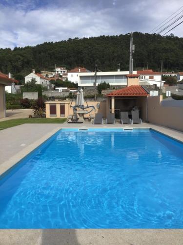 a large blue swimming pool on top of a house at Oceanview Apartments in Viana do Castelo