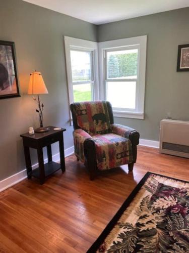 a living room with a chair and a table at Blueberry Cottage Lake Champlain in Plattsburgh