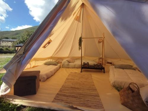 a canvas tent with two beds in it at CAMPING LA ZARAPICA - Palacios del Sil in Palacios del Sil