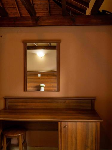 a mirror on the wall of a room with a table at Karyon Apartments in Kariófiton