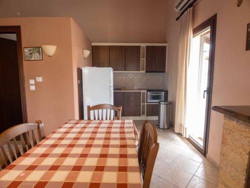 a kitchen with a table and a refrigerator at Karyon Apartments in Kariófiton