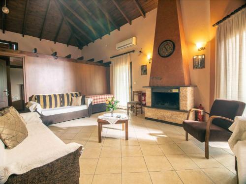 a living room with couches and a fireplace at Karyon Apartments in Kariófiton