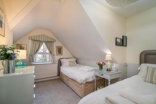 a bedroom with two beds and a window at Whole floor apartment with parking and ferry voucher in Cowes