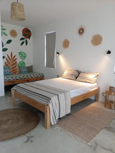 a bedroom with a large bed with a wooden frame at IZAVA LODGE in Rodrigues Island