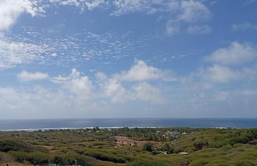 a view of the ocean from the top of a hill at IZAVA LODGE in Rodrigues Island