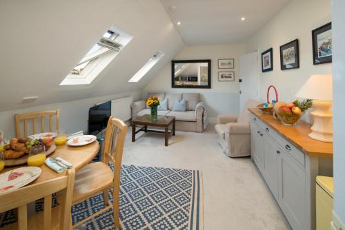 a kitchen and living room with a table and a dining room at 3 BR Central Cowes, Sleeps 8, Sea Views, free parking, ferry voucher LONG TERM DEALS AVAILABLE in Cowes