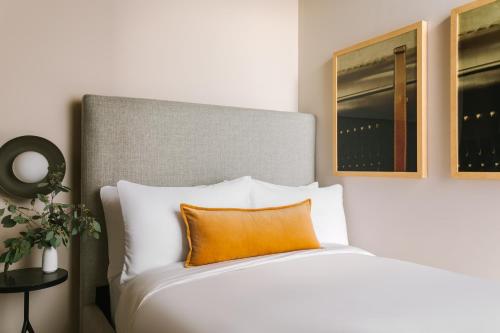 シカゴにあるSonder The Burnhamのベッドルーム1室(オレンジ色の枕付きのベッド1台付)