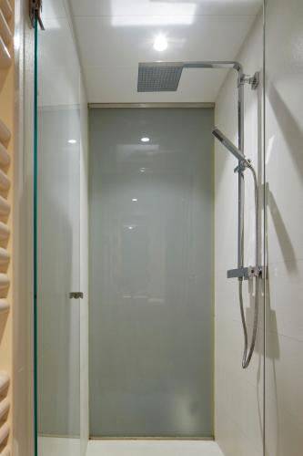 a shower with a glass door in a bathroom at Hotel Landaben in Pamplona