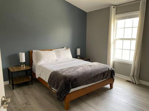 a bedroom with a bed and a window at Luxury Townhome 2 Remodeled February 2021 in Bloomington