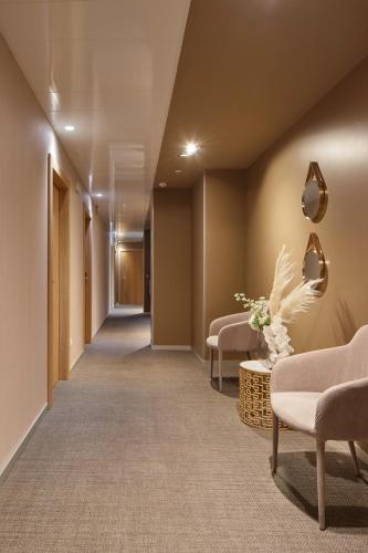 a corridor of a hospital with couches and chairs at Hotel Landaben in Pamplona