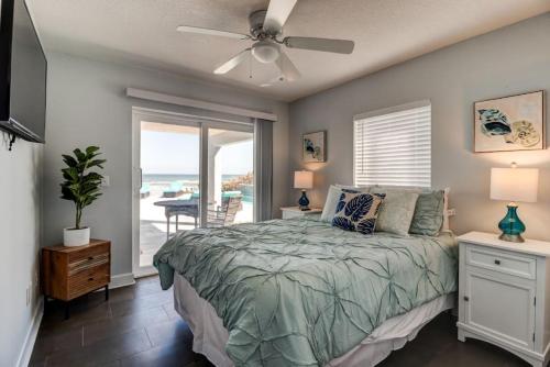 a bedroom with a bed and a ceiling fan at Oceanfront Pool House 7 Bedrooms 7 Bath 2 Kitchens in Port Orange