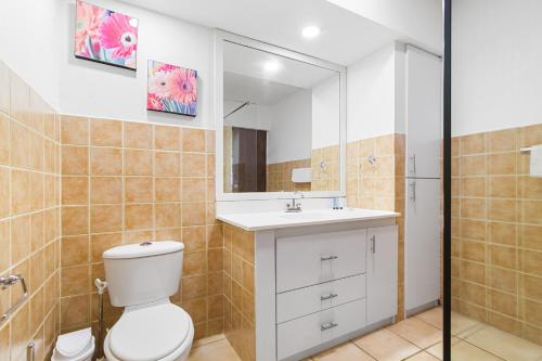 a bathroom with a toilet and a sink and a mirror at Villa Aloe in Paradijs