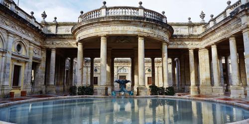 a large building with a large pool in front of it at Come a casa in Monsummano