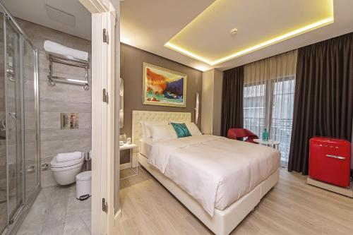a hotel room with a bed and a shower at Barbera Hotel in Istanbul