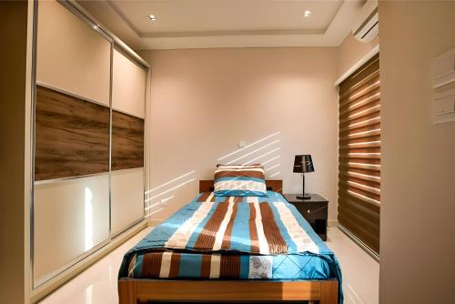 a bedroom with a bed with a wooden headboard at Exquisitely-detailed Home in Yaba, Lagos in Lagos