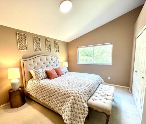 a bedroom with a large bed and a window at Contemporary Turnagain Townhome in Anchorage