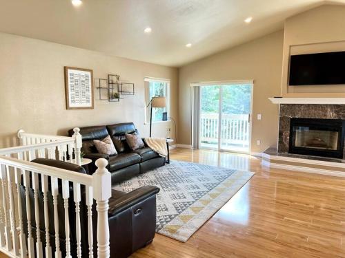 a living room with a couch and a fireplace at Contemporary Turnagain Townhome in Anchorage