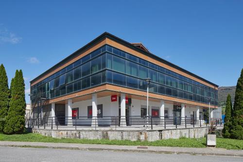 a large glass building with red doors at Leizarooms in Leitza