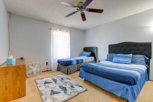 a bedroom with two beds and a ceiling fan at Spacious Aurora Retreat with Game Room and Hot Tub! in Aurora