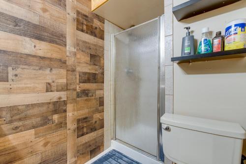 a bathroom with a shower and a toilet at Spacious Aurora Retreat with Game Room and Hot Tub! in Aurora